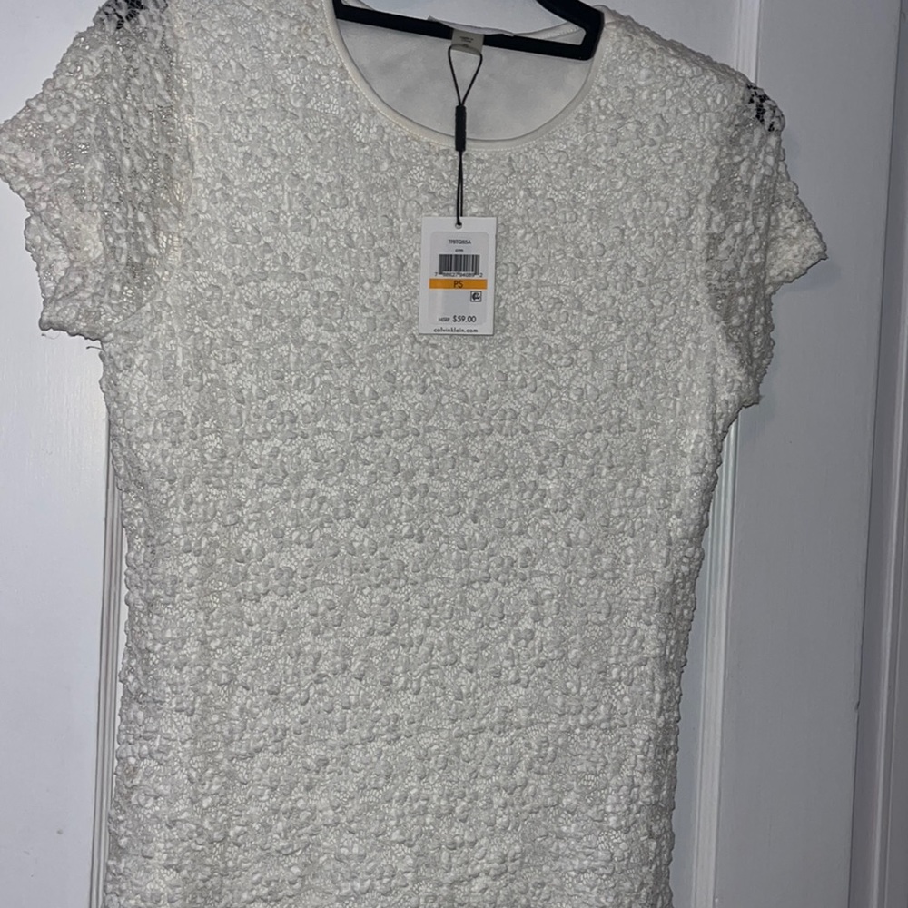 White Calvin Klein with detailing top.